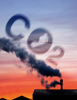 Factory chimney releasing steam at dusk and global warming concept increasing carbon dioxide emissions into the atmosphere